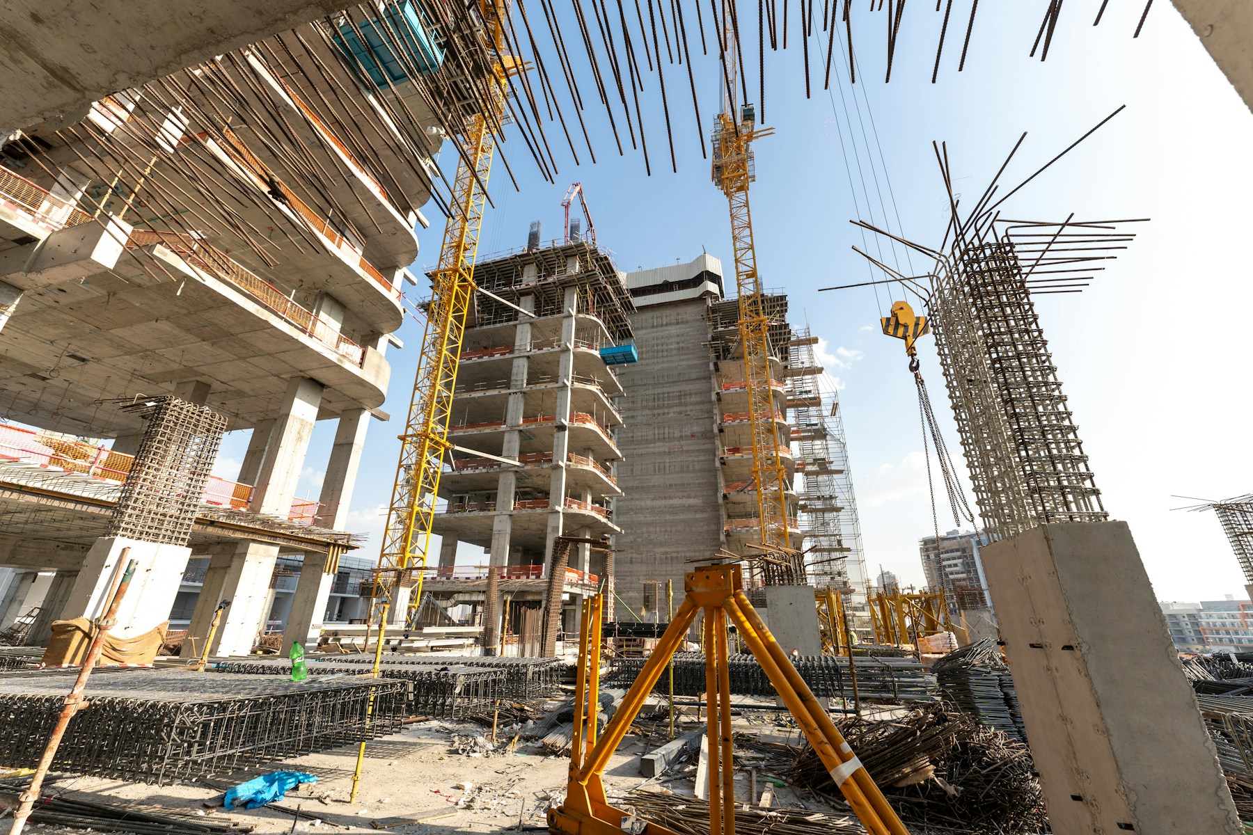Concrete high-rises and tower cranes at a construction site in Dubai